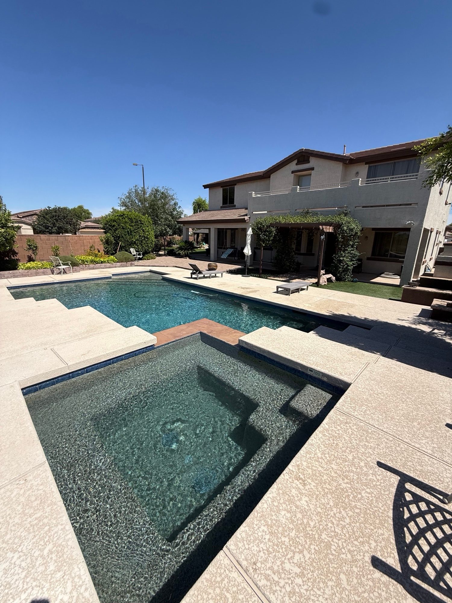 Backyard pool and sunken spa with crystal-clear, balanced water
