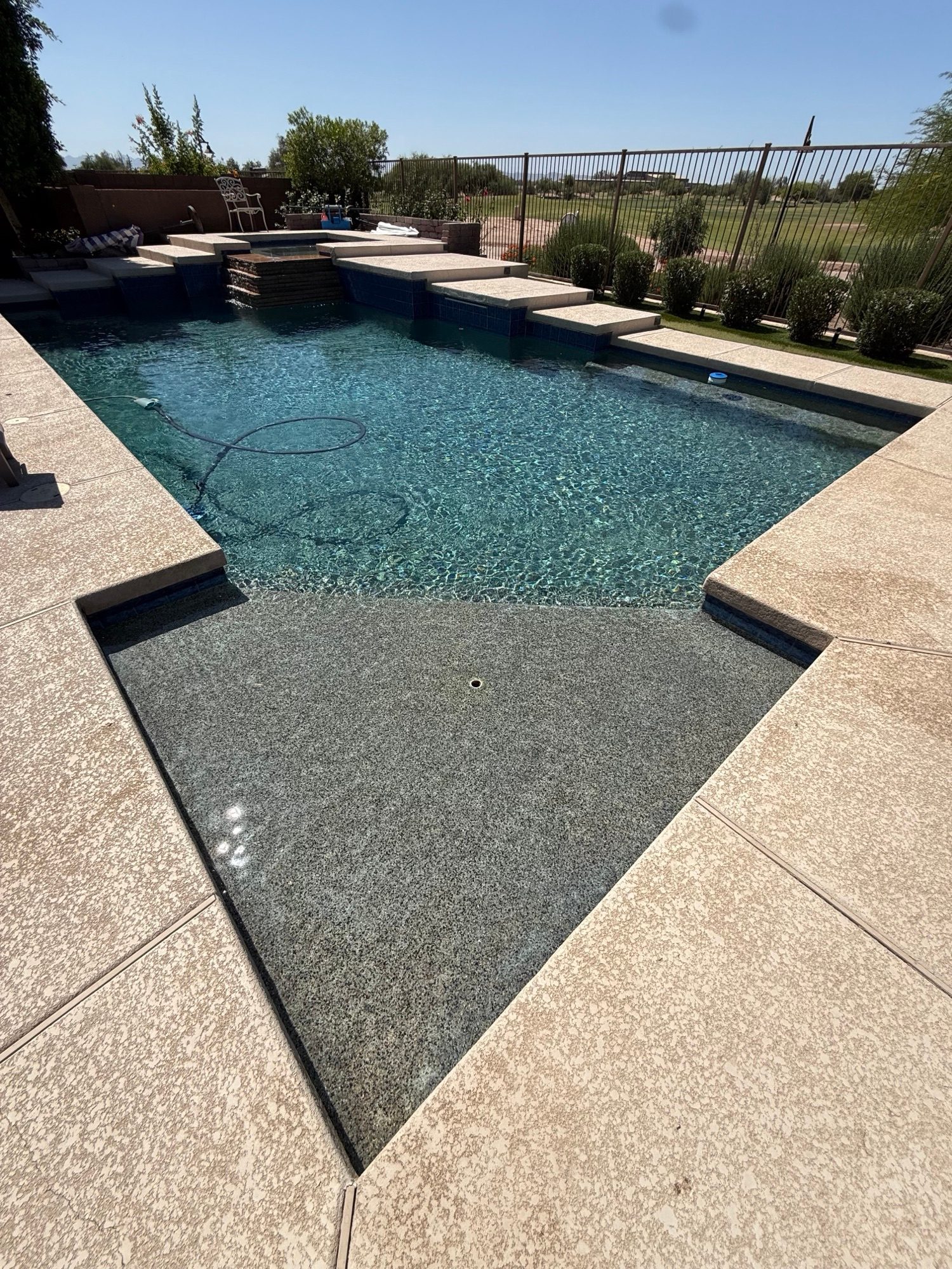Sunken tanning ledge and pool corner with clean, still water